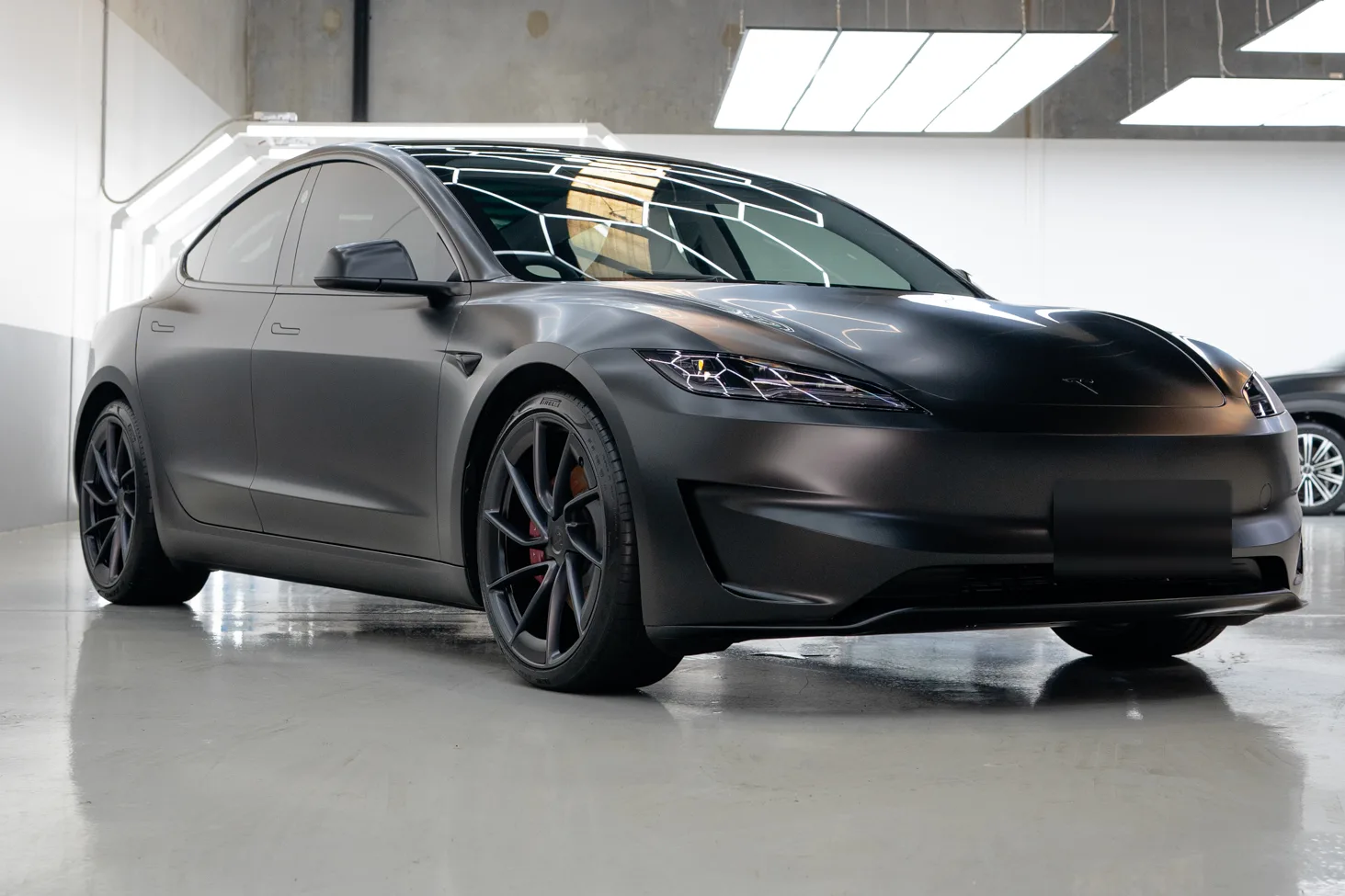 Matte black Tesla Model 3 protected with PPF and ceramic coating at the Deluxe Detail studio