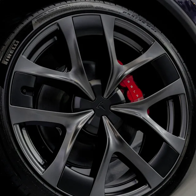 Ceramic coated Tesla wheel with red brake caliper