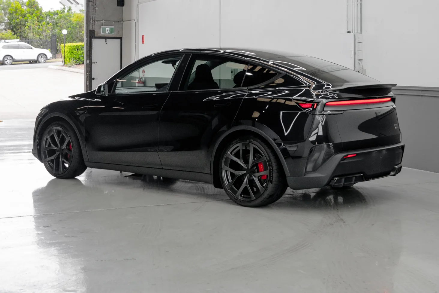 Black Tesla Model Y protected with PPF and ceramic coating at the Deluxe Detail studio