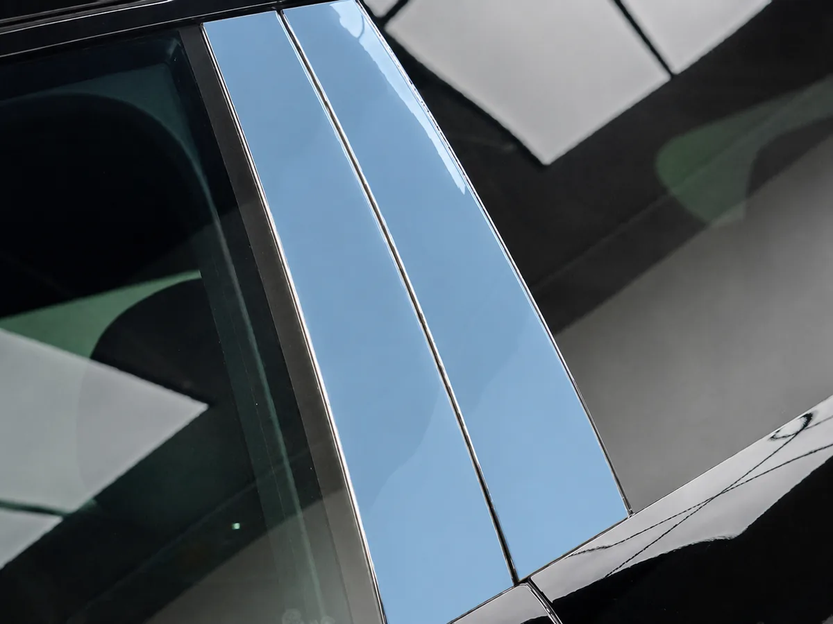 Paint protection film applied to the piano black B and C pillars of a car