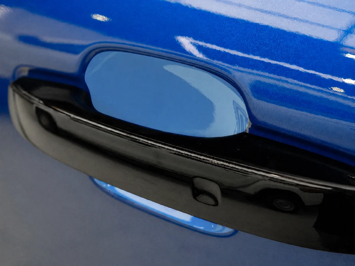 Paint protection film applied to the door cup behind a door handle