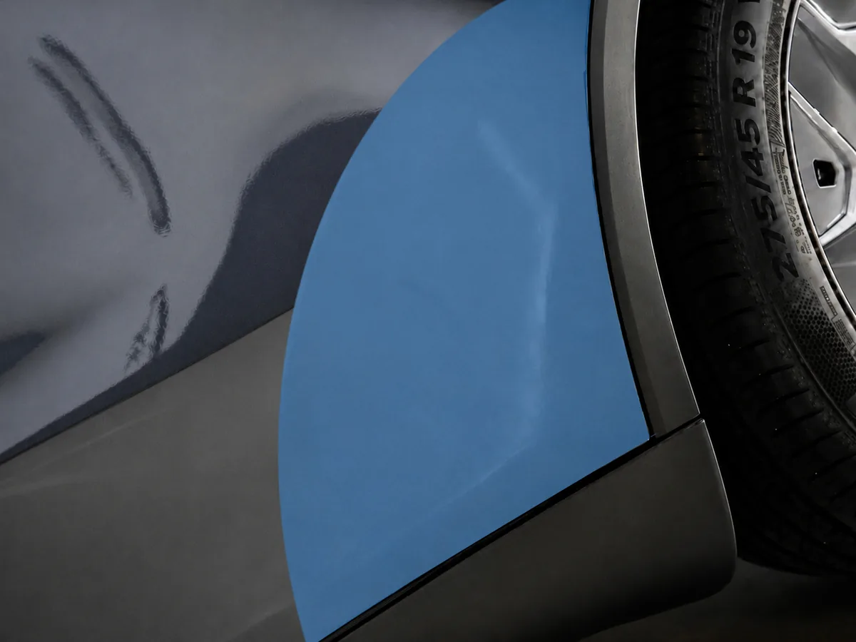 PPF applied to the rear door splash guard of a Tesla Model Y