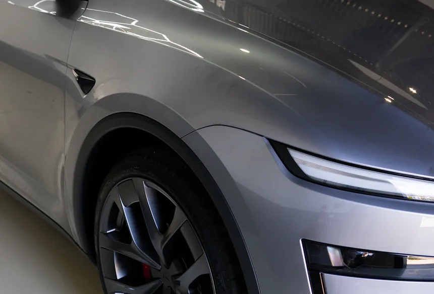 Quicksilver Tesla Model Y front quarter, wheel and red brake caliper after ceramic coating
